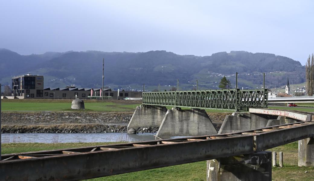 Die Dienstbahnbrücke von der Mädrer Seite des Rheins aus gesehen; links im Hintergrund der Gewerbepark Schützenwiese, rechts die Kirche Kriessern.