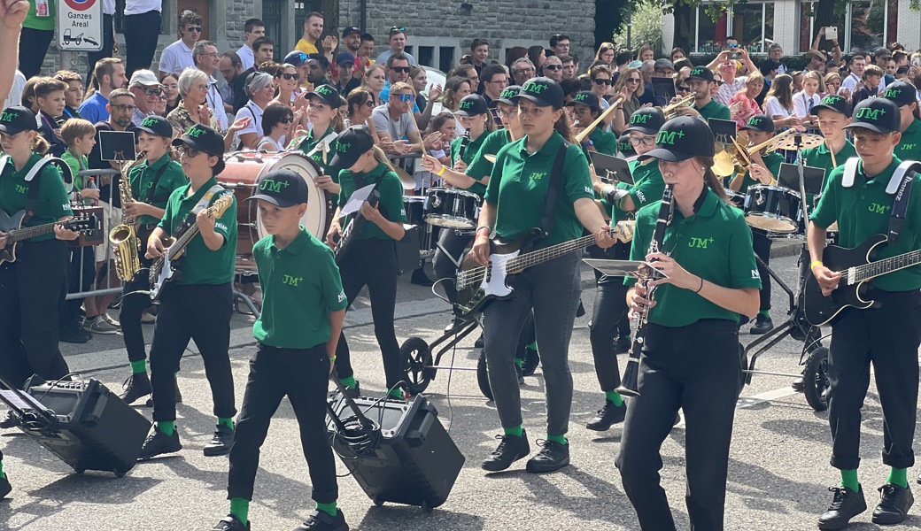 Die Jugendmusik+ in neuer Uniform und mit Verstärkern auf Rädern auf der Parademusik-Strecke in St. Gallen.