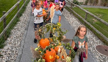 Kinder ziehen 16 geschmückte Leiterwagen durch das Dorf