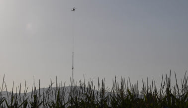 Helikopter baut am frühen Morgen den Windmessmast von SFS ab