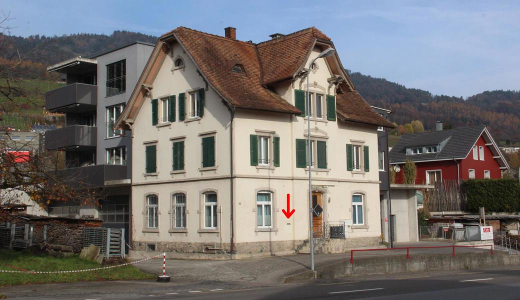 In diesem Gebäude war früher die Post untergebracht, der Briefeinwurf (roter Pfeil) ist noch erkennbar. Auch die Gitter vor zwei der Fenster im Parterre zeugen von der ehemaligen Funktion des Gebäudes als Post.