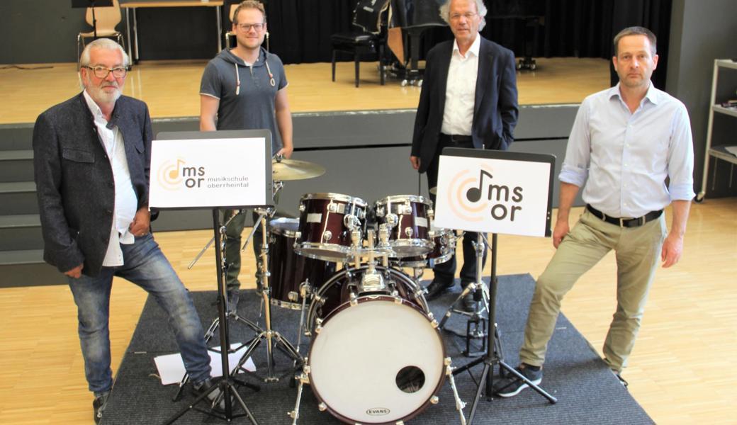 Vom Altstätter Beat Stoller (ganz links) stammt das neue Logo, das auf dem Foto in zwei Varianten zu sehen ist. Nach der Coronazeit sind Schulleiter Roland Aregger (ganz rechts), Musikschulpräsident Alfred Mattle (2. v. r.) und Klavierlehrer Roman Wüthrich froh, dass im Haus wieder Leben herrscht. 