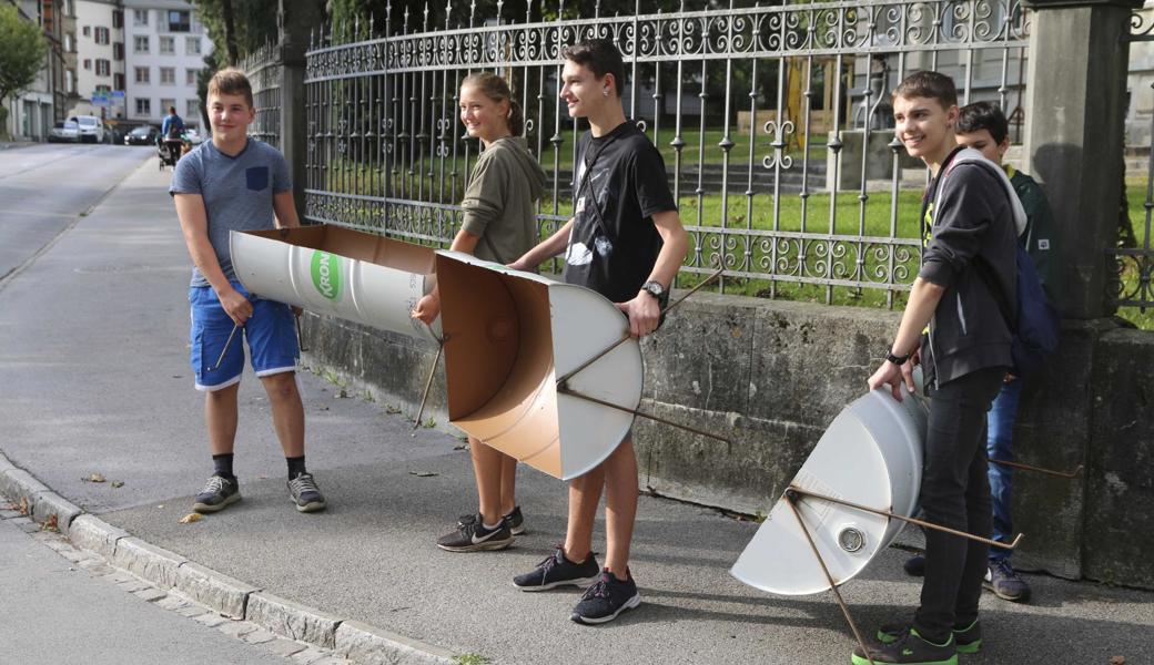 Schüler sind mit den Pflanzgefässen auf dem Weg zur Marktgasse. 