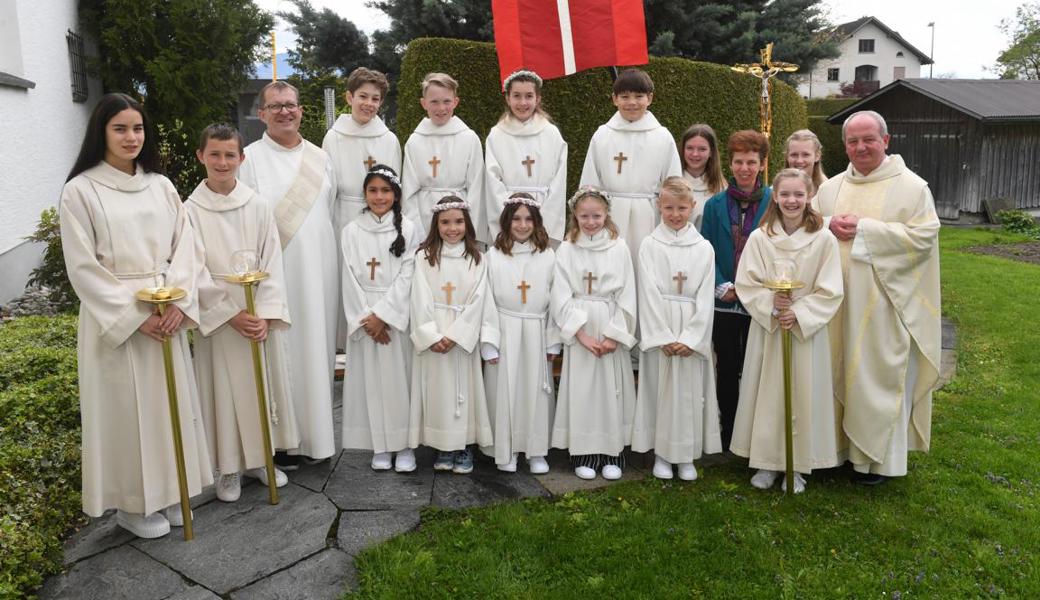 Die neun Erstkommunionkinder aus Eichenwies mit Diakon Donat Haltiner, Veronika Hopfner-Schilling und Pfarrer Waldemar Piatkowski (rechts).