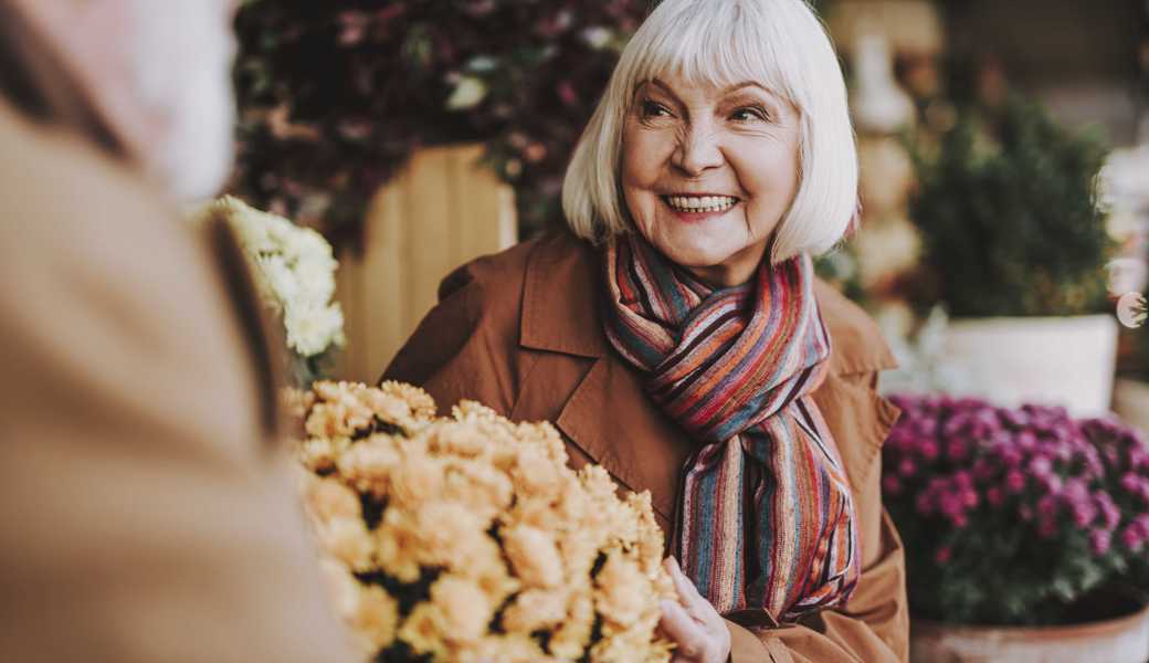 Portrait of joyful senior lady looking at gentleman with admiration and smiling