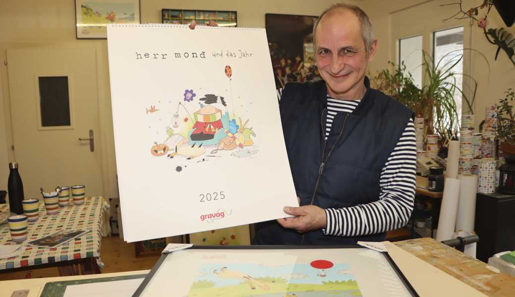 Mit einem spitzbübischen Lächeln präsentiert Patrick Steiger seinen ersten, selbst gestalteten Kalender. 